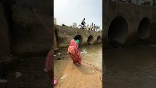 A woman catches fish from a large dam with a hook  amazing fishing in the canal  fishing shorts [upl. by Neltiac]