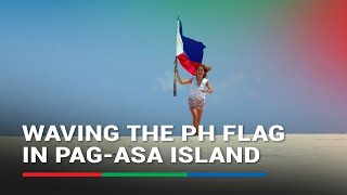 Filipino traveler waves Philippine flag in Pagasa Island  ABSCBN News [upl. by Colfin]