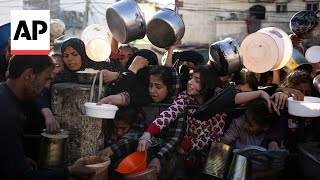 Starving Palestinians in Gaza receive meals from volunteers at start of Ramadan [upl. by Durkee]