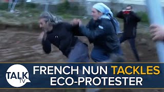 French Nun Tackles EcoProtester Outside Religious Building [upl. by Omidyar]