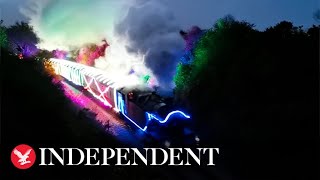 Steam train decked out in vibrant neon lights passes through countryside [upl. by Akina]