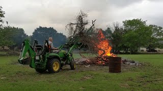 Burning Brush with a John Deere 2025R and AV20F Grapple [upl. by Rabma]