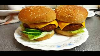 Grilling Halal Lamb burgers on a non stick fry pan  served with fried lettuce gherkins cheese [upl. by Atalanti]