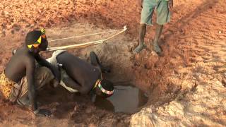 Hadzabe bushmen drinking water from river bed [upl. by Arakat]