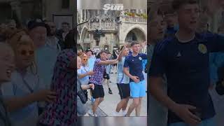 Scotland fans drink pub dry then conga through Munich streets [upl. by Derdle703]