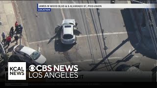 Robbery pursuit suspect crashes into another vehicle at a South Los Angeles intersection flees on f [upl. by Moss]