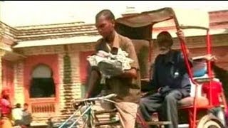 This rickshaw puller has a child strapped to his chest [upl. by Bernadine]