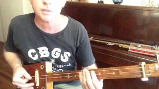 How to play Folsom Prison Blues on a 3 string slide cigar box guitar by Nigel McTrustry [upl. by Secunda568]