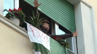 Coronavirus Italians sing under lockdown  AFP [upl. by Ahtnama]