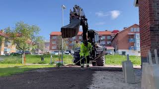 HUDDIG 1260E backhoe loader with Rototilt R4 leveling topsoil with grading beam [upl. by Eylrahc716]