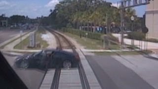 Woman narrowly misses train after car stalls on tracks [upl. by Zehcnas822]