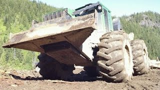 John deere skidder pulling Kenworth T800 log truck up steep hill [upl. by Ailatan]